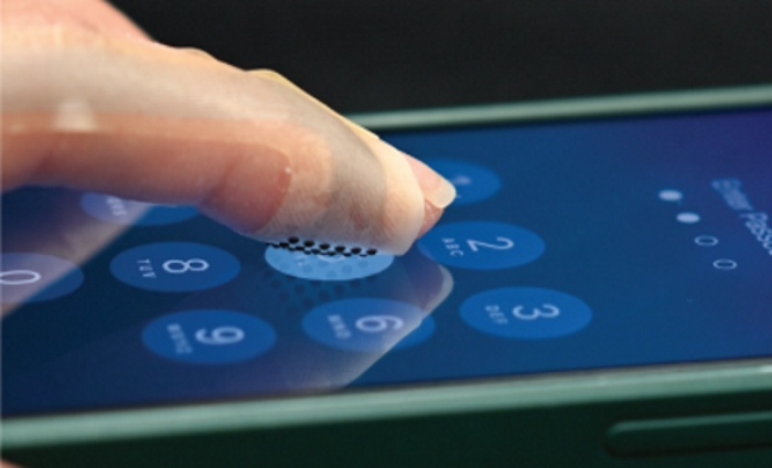 Haptic wearable that looks like a finger plaster can feel textures on a touch display